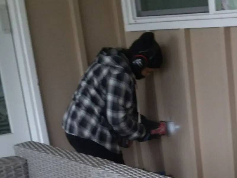 Professional electrician installing an exterior outlet in Webster